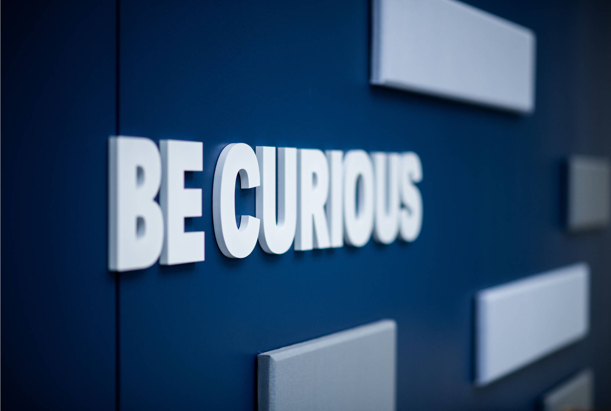 A sign that says "Be Curious"